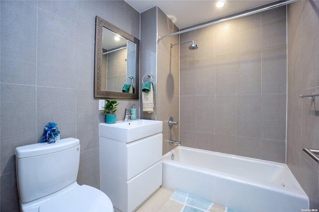 full bathroom with vanity, tiled shower / bath combo, and toilet