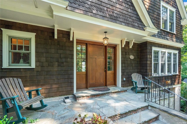 view of exterior entry with a porch