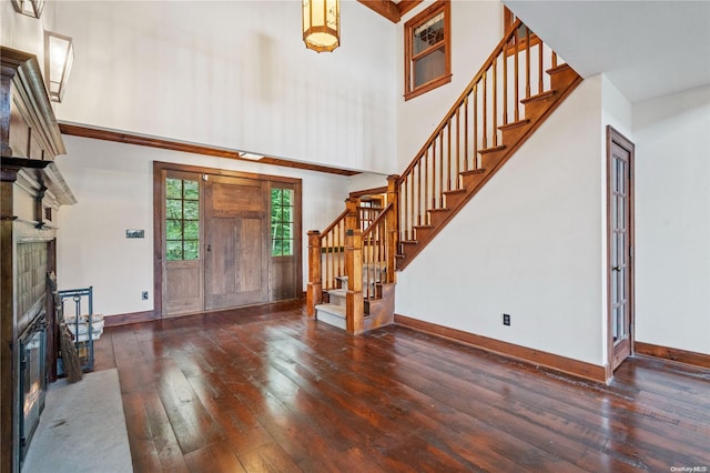 entrance foyer with dark hardwood / wood-style flooring and a high ceiling