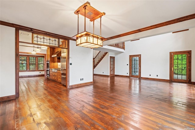 unfurnished living room with a high ceiling, dark hardwood / wood-style flooring, ceiling fan, and beam ceiling