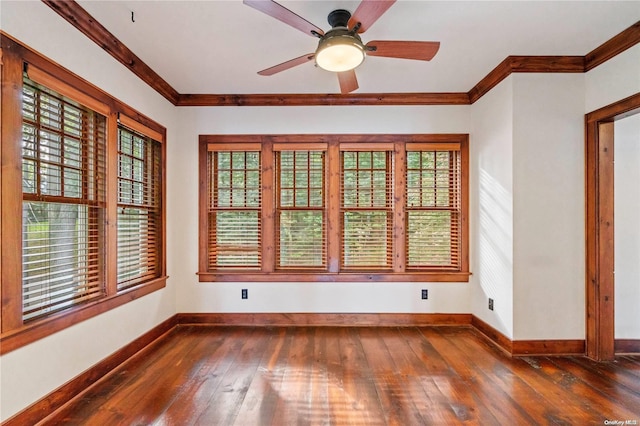 spare room featuring crown molding, ceiling fan, and dark wood-type flooring