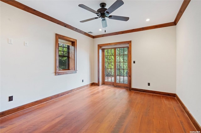 empty room with ceiling fan, french doors, ornamental molding, and light wood-type flooring