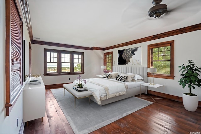 bedroom with dark hardwood / wood-style flooring and ornamental molding