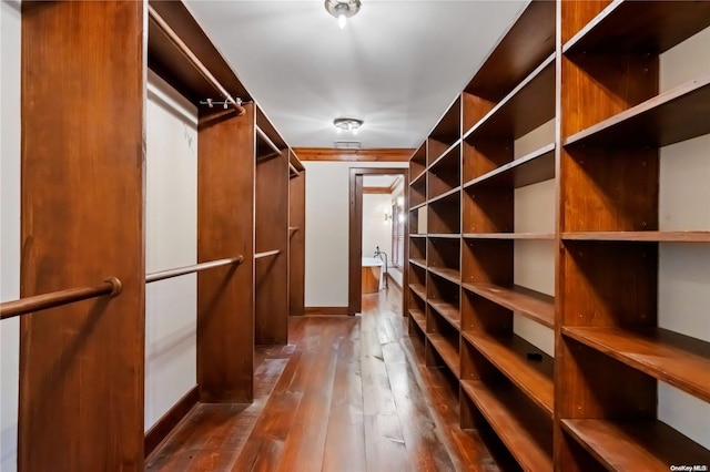 walk in closet featuring dark wood-type flooring