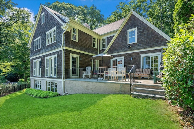 rear view of house featuring a lawn