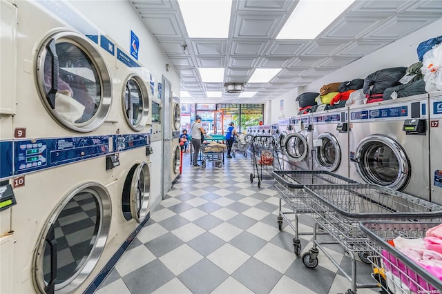 laundry room featuring stacked washer / dryer and washer and dryer