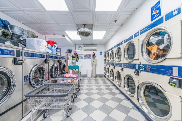 washroom featuring separate washer and dryer and a wall unit AC