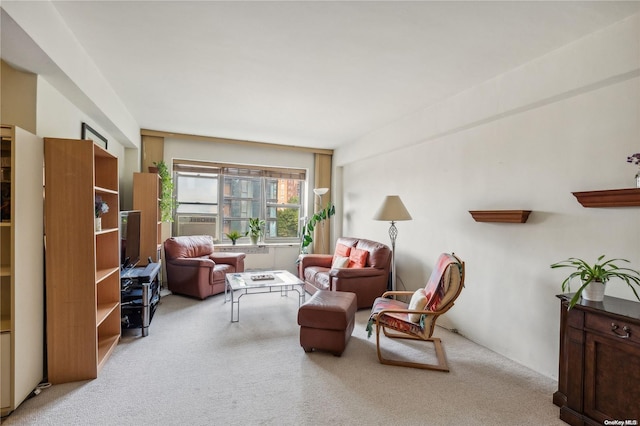 living area with cooling unit and light colored carpet