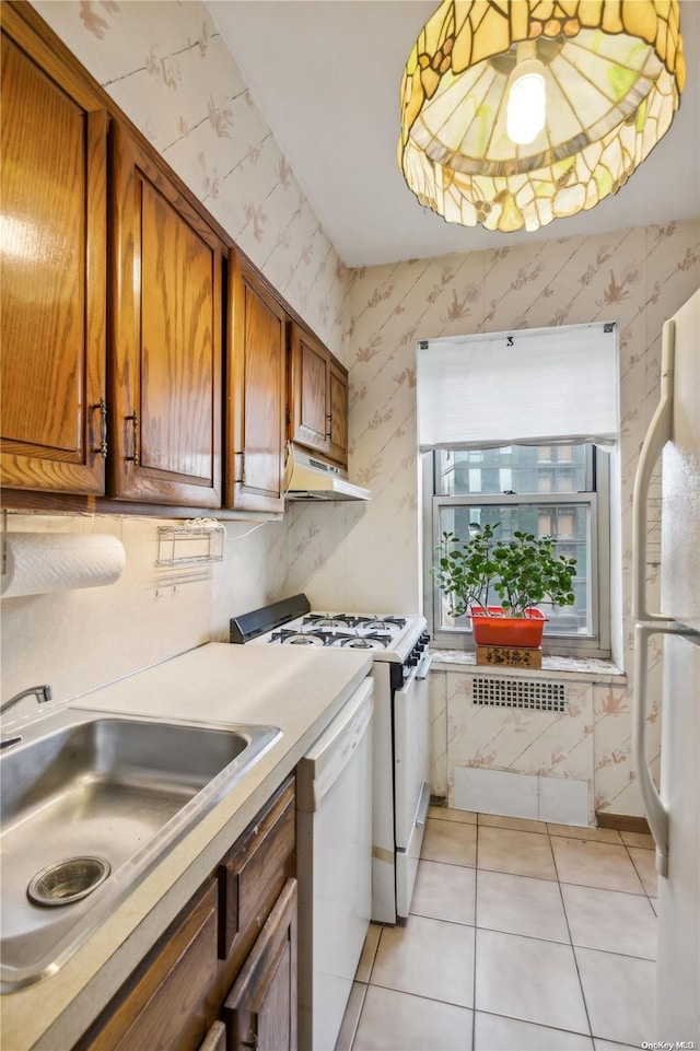 laundry room featuring light tile patterned floors and sink