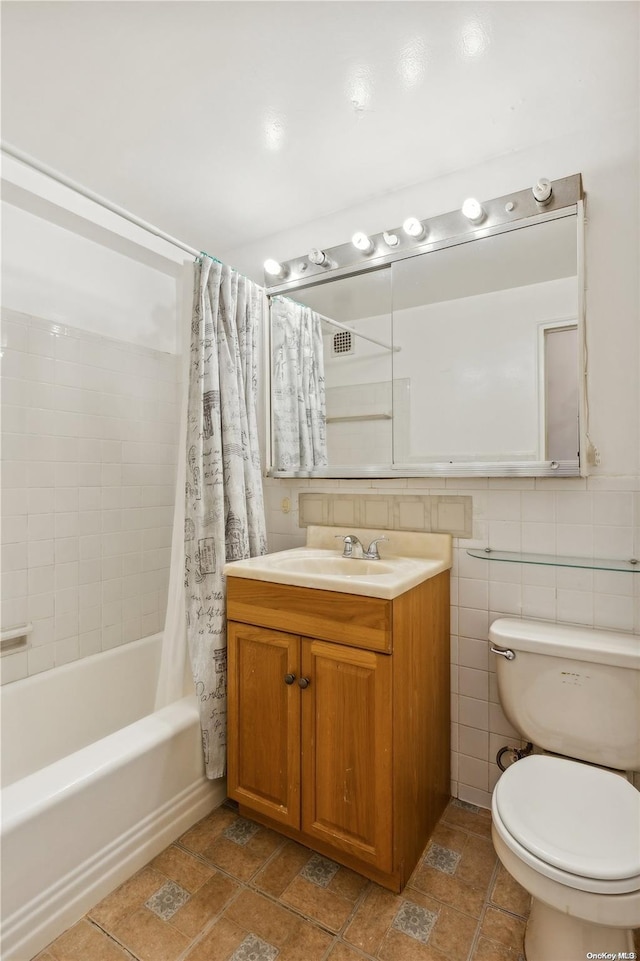 full bathroom with shower / bath combination with curtain, vanity, toilet, and tile walls