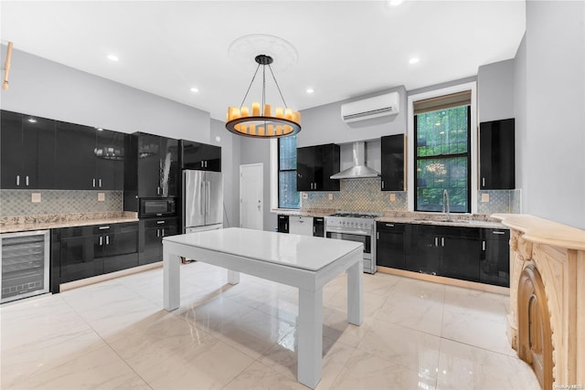 kitchen with stainless steel appliances, beverage cooler, wall chimney range hood, decorative light fixtures, and an AC wall unit