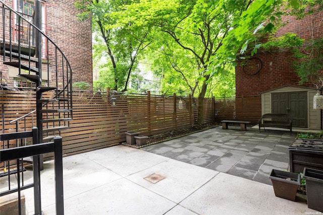 view of patio / terrace featuring a storage shed