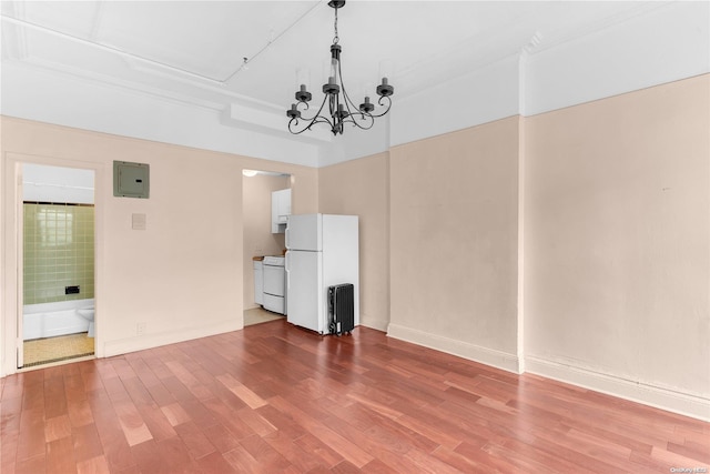 interior space with electric panel, hardwood / wood-style floors, and a chandelier