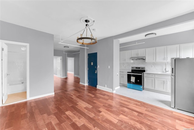 kitchen featuring appliances with stainless steel finishes, light hardwood / wood-style floors, and white cabinetry