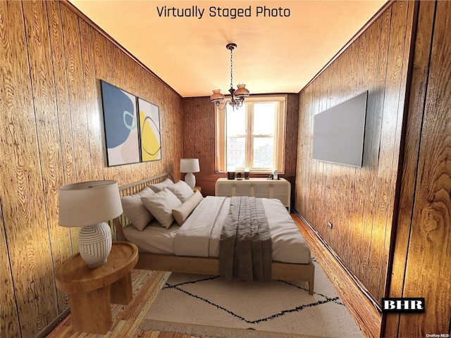 bedroom featuring a chandelier, ornamental molding, light hardwood / wood-style flooring, and wooden walls