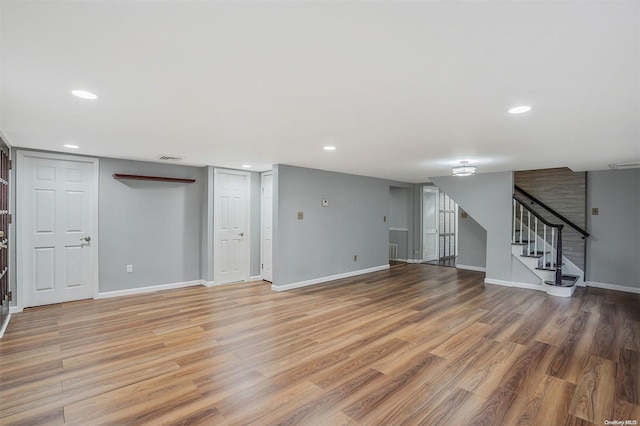 unfurnished living room with wood-type flooring