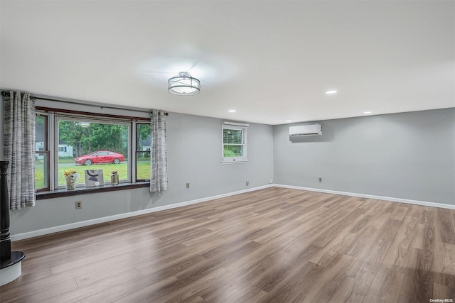 interior space featuring light hardwood / wood-style flooring and a wall mounted air conditioner