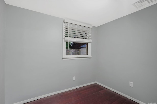 empty room featuring dark hardwood / wood-style flooring