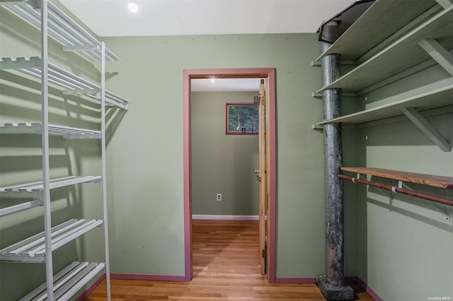 spacious closet with light hardwood / wood-style floors