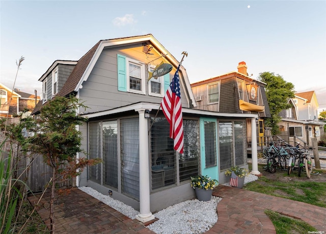 rear view of property featuring a sunroom