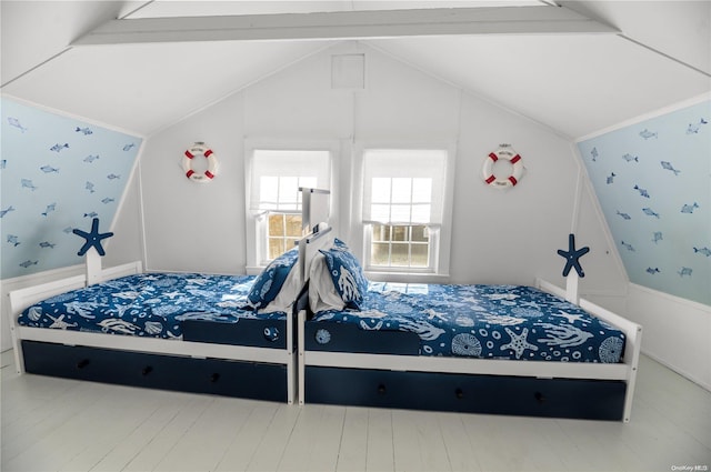 bedroom featuring hardwood / wood-style floors and lofted ceiling