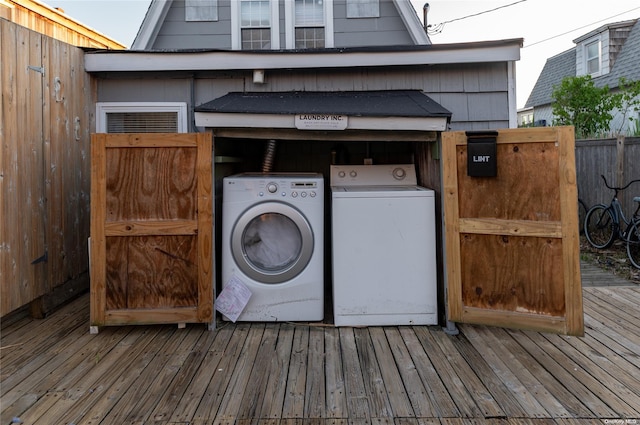 laundry area with washer and dryer and wood-type flooring