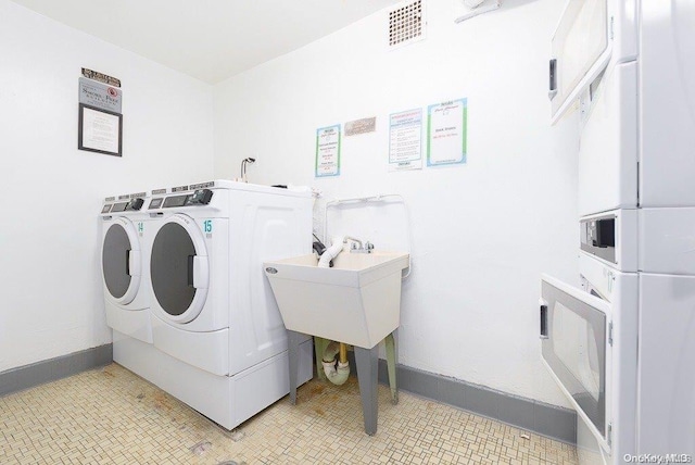 washroom with washer and dryer and sink