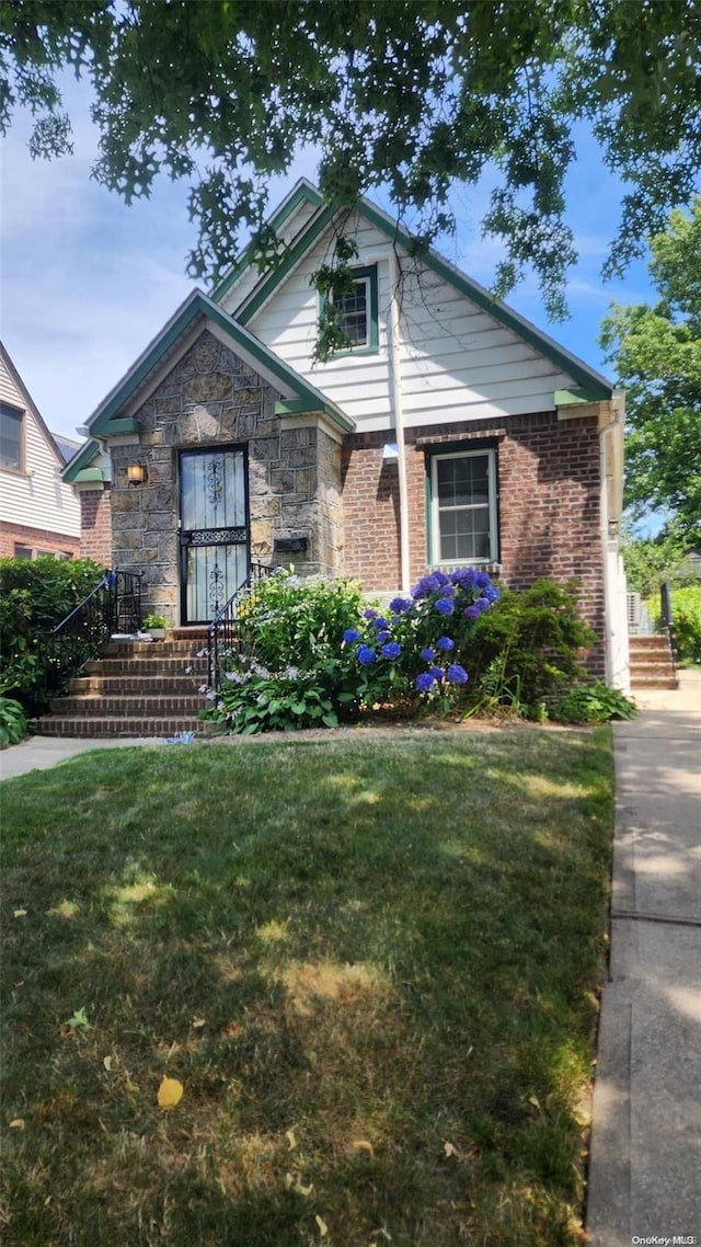 48-27 213th St, Bayside, NY 11364 - view of front of home featuring a front yard and stone siding
