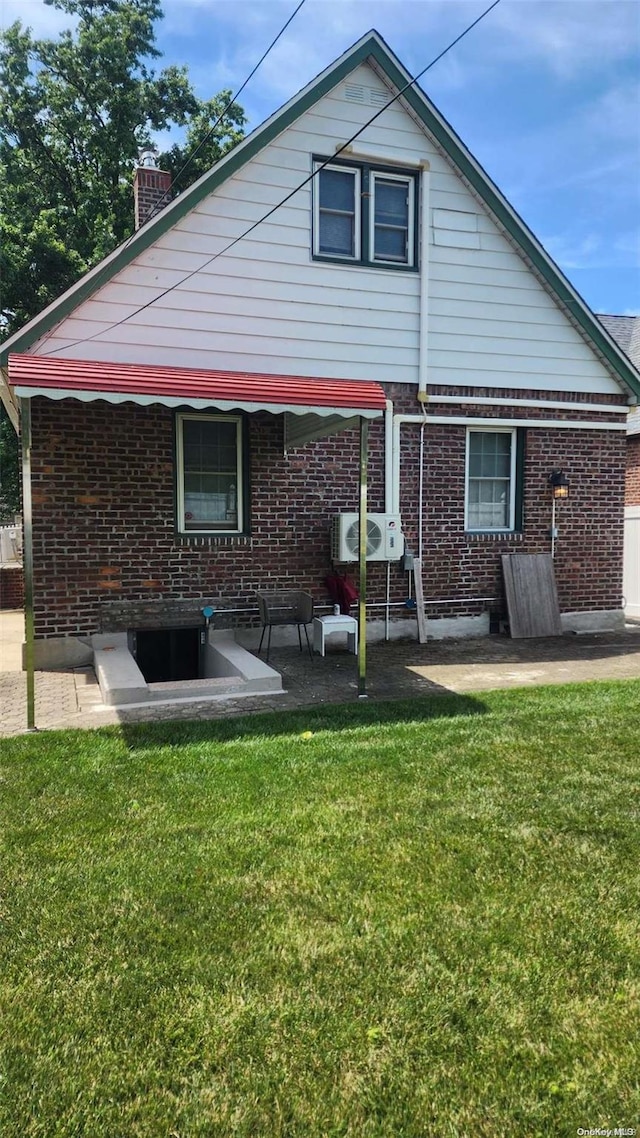 48-27 213th St, Bayside, NY 11364 - rear view of house with brick siding, a yard, and a chimney