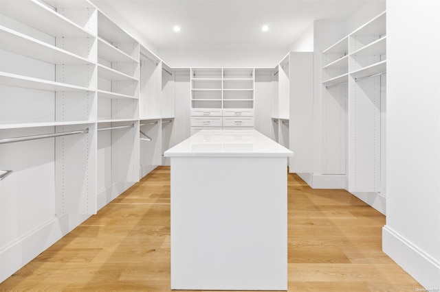 spacious closet with light hardwood / wood-style floors