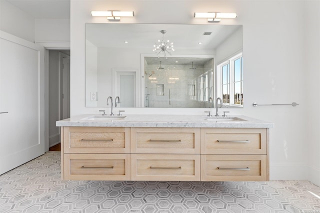 bathroom featuring vanity, an enclosed shower, and a chandelier