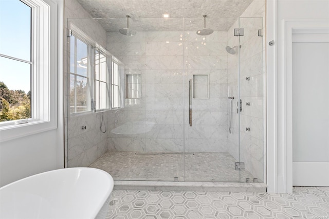 bathroom with tile patterned floors and independent shower and bath