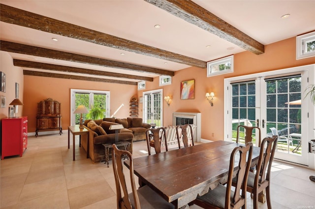 dining area with beam ceiling and french doors