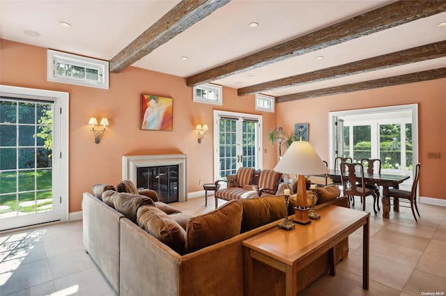 living room featuring beam ceiling, french doors, light tile patterned floors, and plenty of natural light