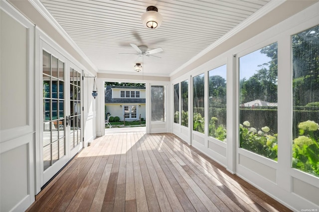 unfurnished sunroom featuring ceiling fan