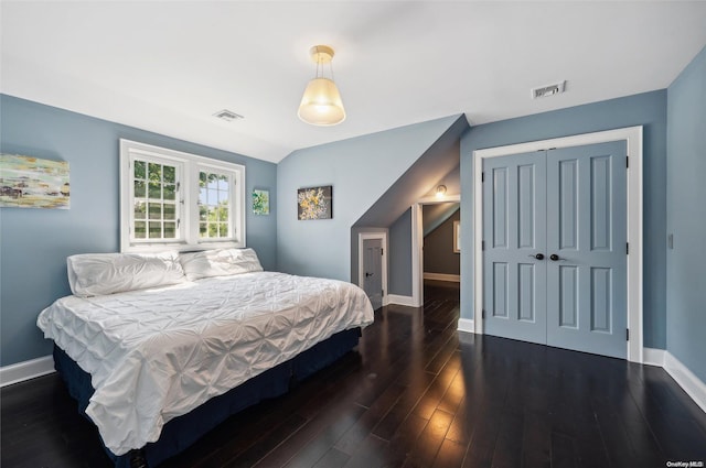 bedroom featuring a closet and dark wood-type flooring