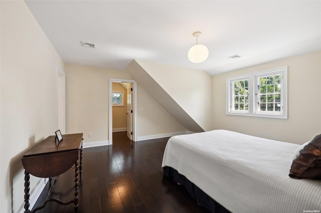 bedroom with dark hardwood / wood-style flooring