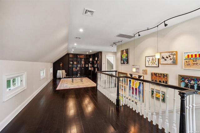 hallway featuring dark hardwood / wood-style floors and vaulted ceiling