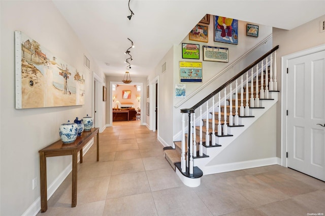 tiled entrance foyer featuring track lighting