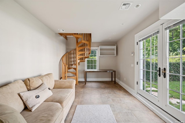 unfurnished living room featuring french doors