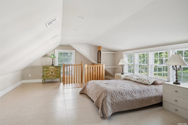 tiled bedroom with lofted ceiling