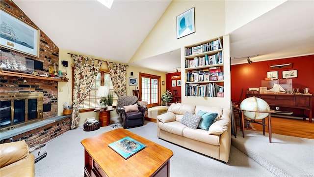 carpeted living room with a brick fireplace and lofted ceiling