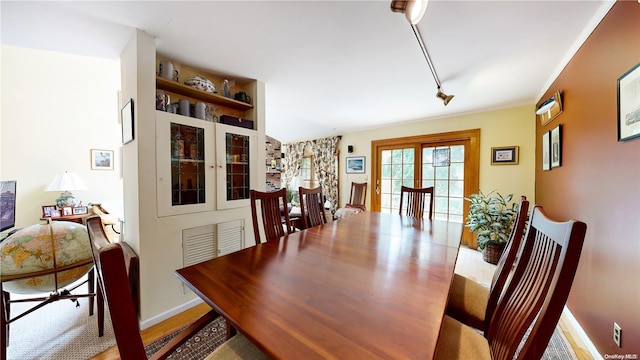 dining area featuring light hardwood / wood-style floors and track lighting