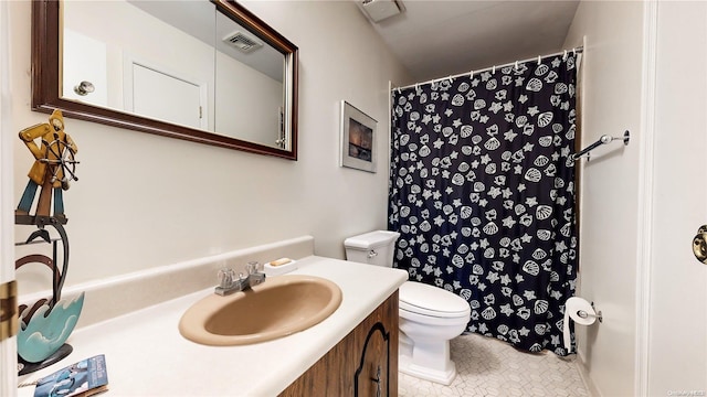 bathroom with tile patterned floors, vanity, and toilet