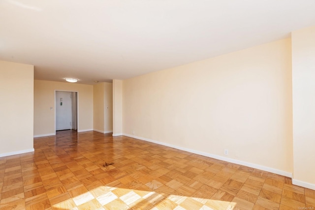 unfurnished room featuring light parquet flooring