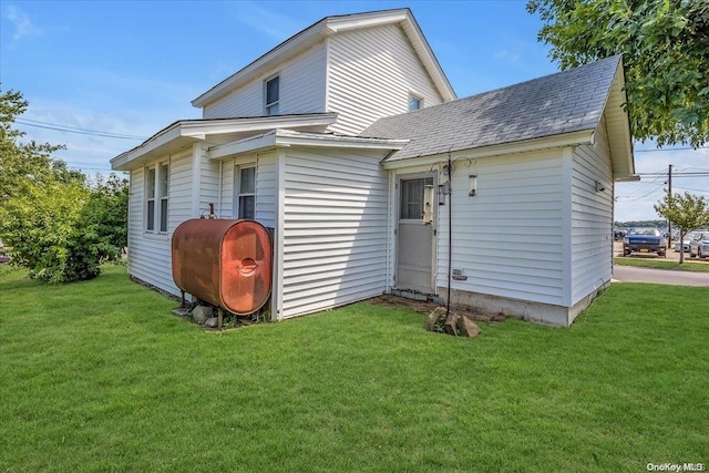 rear view of property featuring a yard