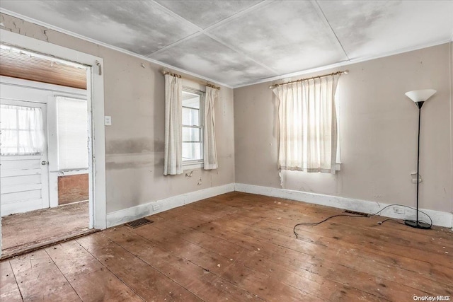 empty room with hardwood / wood-style floors and a wealth of natural light