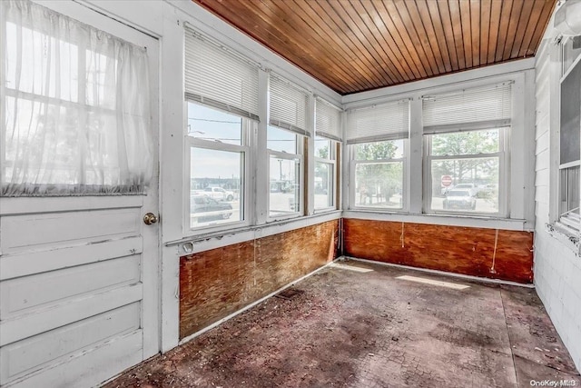 unfurnished sunroom featuring wood ceiling