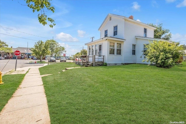 view of side of home featuring a lawn