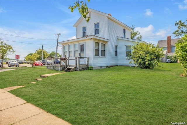 back of house featuring a lawn